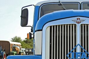 Front of a big rig including the side mirror