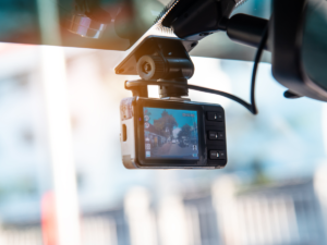 A dashcam on a car windshield.