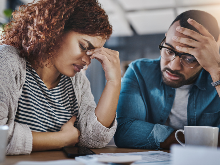 A grieving woman at a desk with a business professional